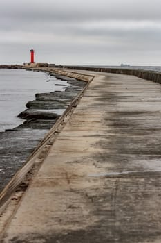 Breakwater dam with red lighthouse in Riga, Europe