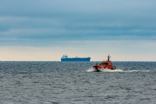 Red pilot ship moving at speed in Baltic sea