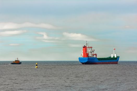 Blue cargo ship entering the Baltic sea. Riga, Europe