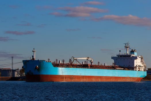 Blue cargo ship loading in the port of Riga, Europe