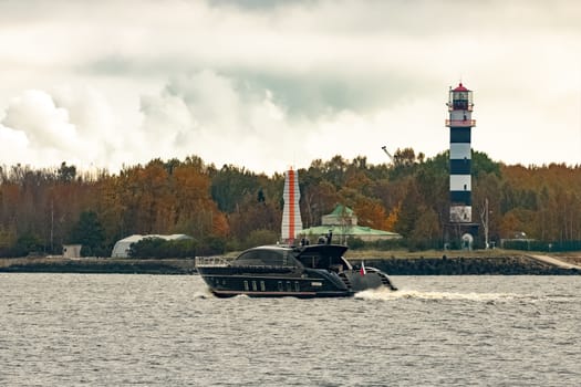 Black elite speed motor boat entering Riga