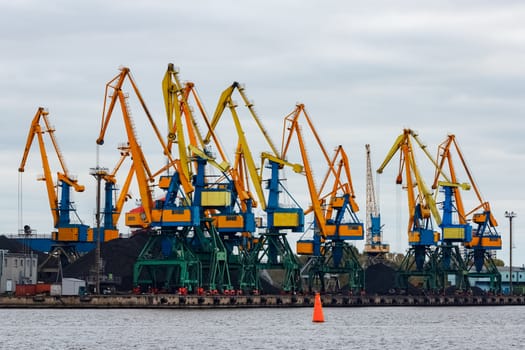 Yellow cargo cranes in the port of Riga, Europe