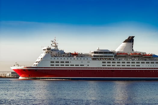 Red cruise liner. Passenger ferry ship sailing in still water