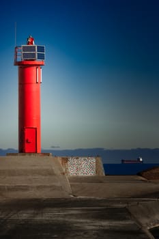 Red lighthouse on breakwater dam in Riga, Europe