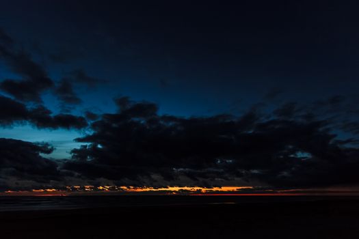 Dark blue cloudy sky over the Baltic sea at night