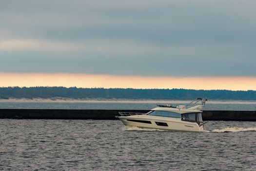 White small speed boat sailing in still water