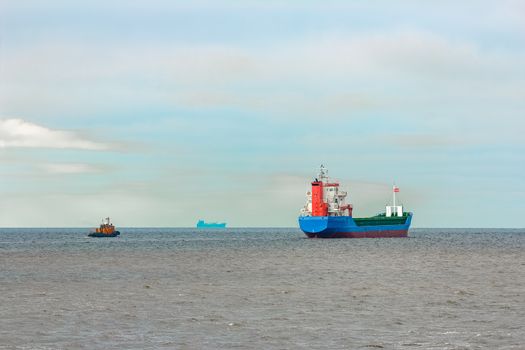 Blue cargo ship entering the Baltic sea. Riga, Europe