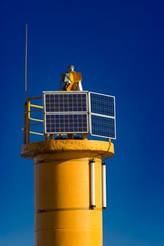 Yellow lighthouse against blue sky in Riga, Europe