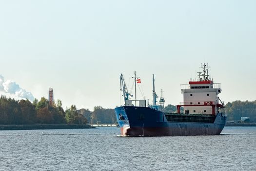 Blue cargo ship leaving the port of Riga