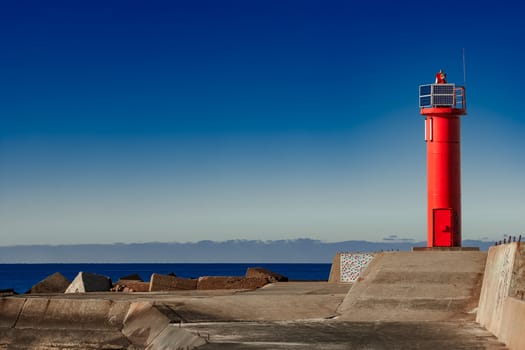 Red lighthouse on breakwater dam in Riga, Europe