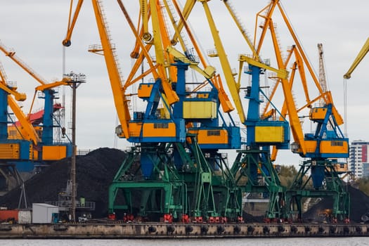 Yellow cargo cranes in the port of Riga, Europe