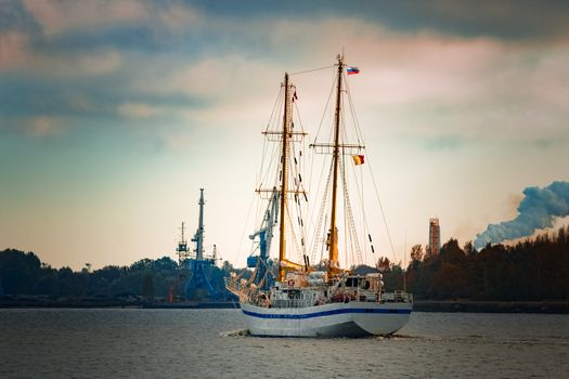 White sailing ship coming from Baltic sea and entering Riga