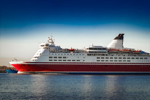 Red cruise liner. Passenger ferry ship sailing in still water