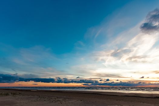 Blue cloudy sky over the Baltic sea at evening