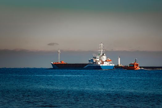 Blue cargo ship leaving Riga and entering Baltic sea