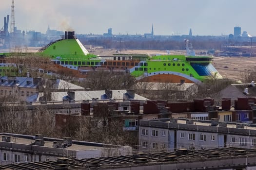 Green cruise liner. Passenger ferry sailing past the Riga city