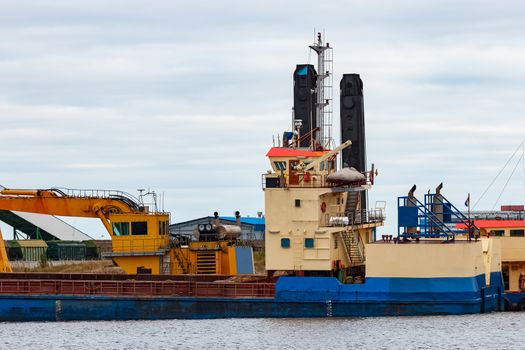 Blue cargo ship loading in the port of Riga, Europe