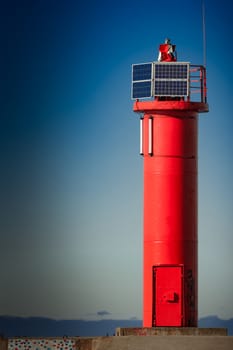 Red lighthouse on breakwater dam in Riga, Europe