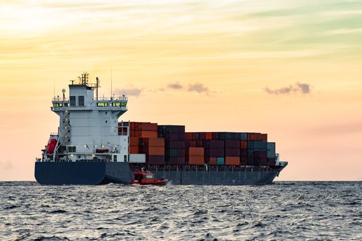 Blue container ship leaving Riga and entering Baltic sea