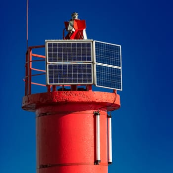 Red lighthouse against blue sky in Riga, Europe