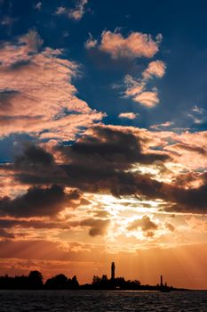 Golden sunset sky over the town silhouette