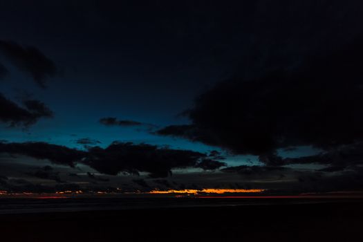 Dark blue cloudy sky over the Baltic sea at night