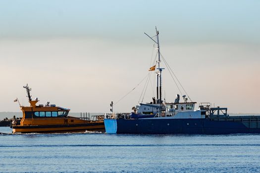 Blue cargo ship leaving Riga and entering Baltic sea