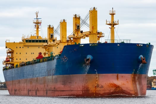 Blue cargo ship entering the port of Riga, Europe