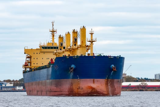 Blue cargo ship entering the port of Riga, Europe