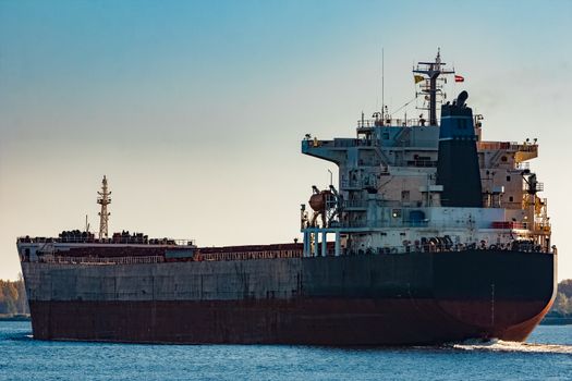 Black cargo ship entering Riga, Europe