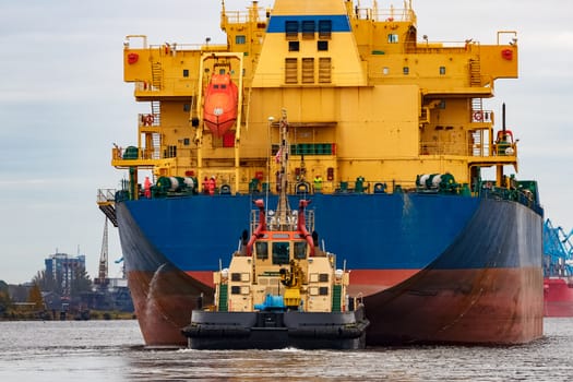 Blue cargo ship entering the port of Riga, Europe