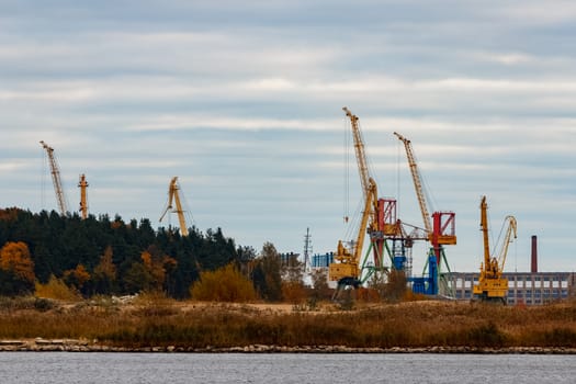 Yellow cargo cranes in the port of Riga