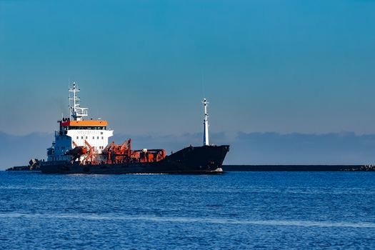 Black cargo oil tanker sailing in still water from Baltic sea