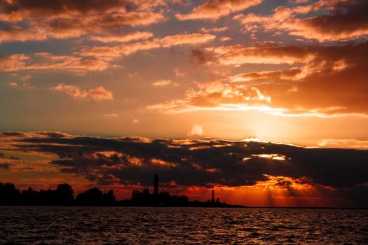 Golden sunset sky over the town silhouette