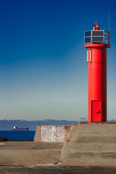 Red lighthouse on breakwater dam in Riga, Europe