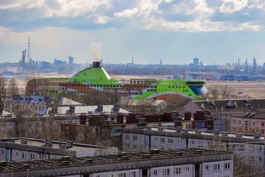 Green cruise liner. Passenger ferry sailing past the Riga city