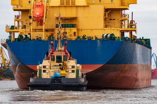 Blue cargo ship entering the port of Riga, Europe