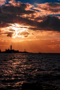 Golden sunset sky over the town silhouette