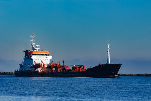 Black cargo oil tanker sailing in still water from Baltic sea
