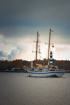 White sailing ship coming from Baltic sea and entering Riga