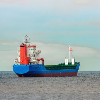 Blue cargo ship entering the Baltic sea. Riga, Europe