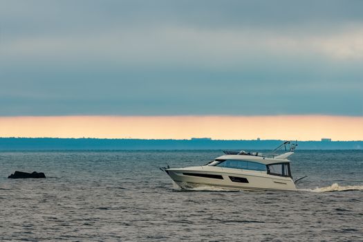 White small speed boat sailing in still water
