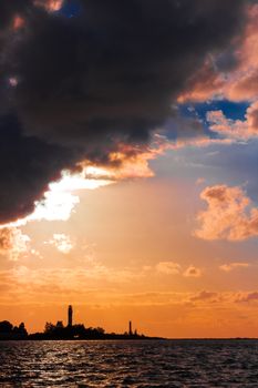 Golden sunset sky over the town silhouette