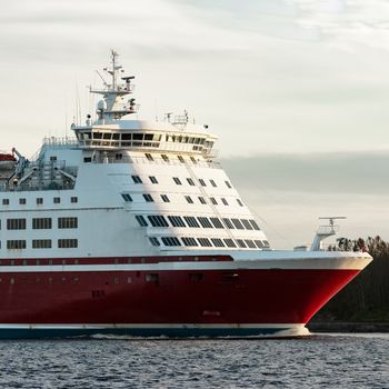 Red cruise liner's bow. Passenger ferry underway