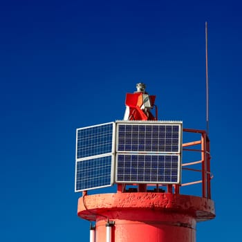 Red lighthouse against blue sky in Riga, Europe