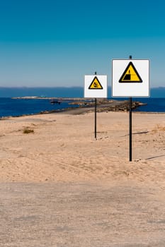 Yellow warning signs on summer beach, Riga