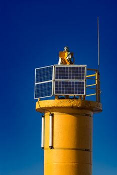 Yellow lighthouse against blue sky in Riga, Europe