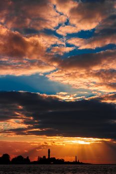 Golden sunset sky over the town silhouette