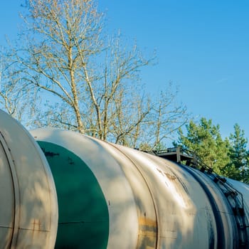 Tank wagons with oil. Freight train in forest