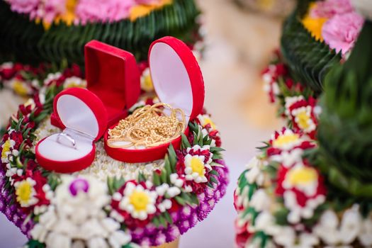 Dowry (gold necklace) on flower tray in Thai traditional wedding